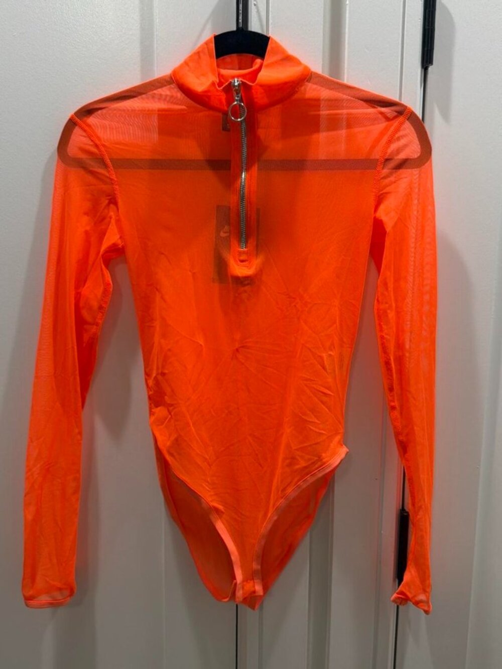 Orange mesh bodysuit with zipper detail and thumb detail